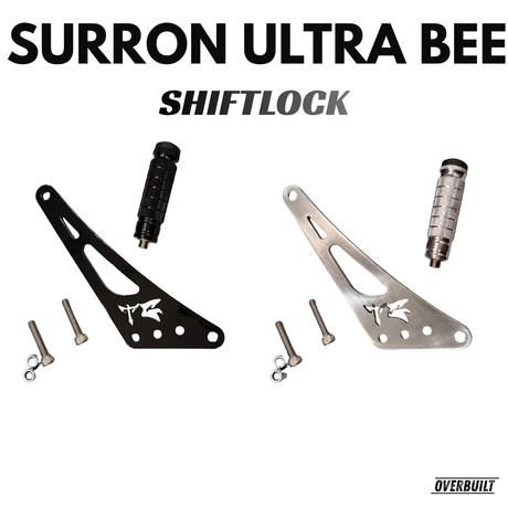 Top view of shift/foot lock with a white background showcasing both colors, and all hardware and bolts and spacers included, with the pegs for the shift lock done as well. Gloss black and chrome shift locks