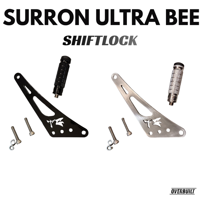 Top view of shift/foot lock with a white background showcasing both colors, and all hardware and bolts and spacers included, with the pegs for the shift lock done as well. Gloss black and chrome shift locks