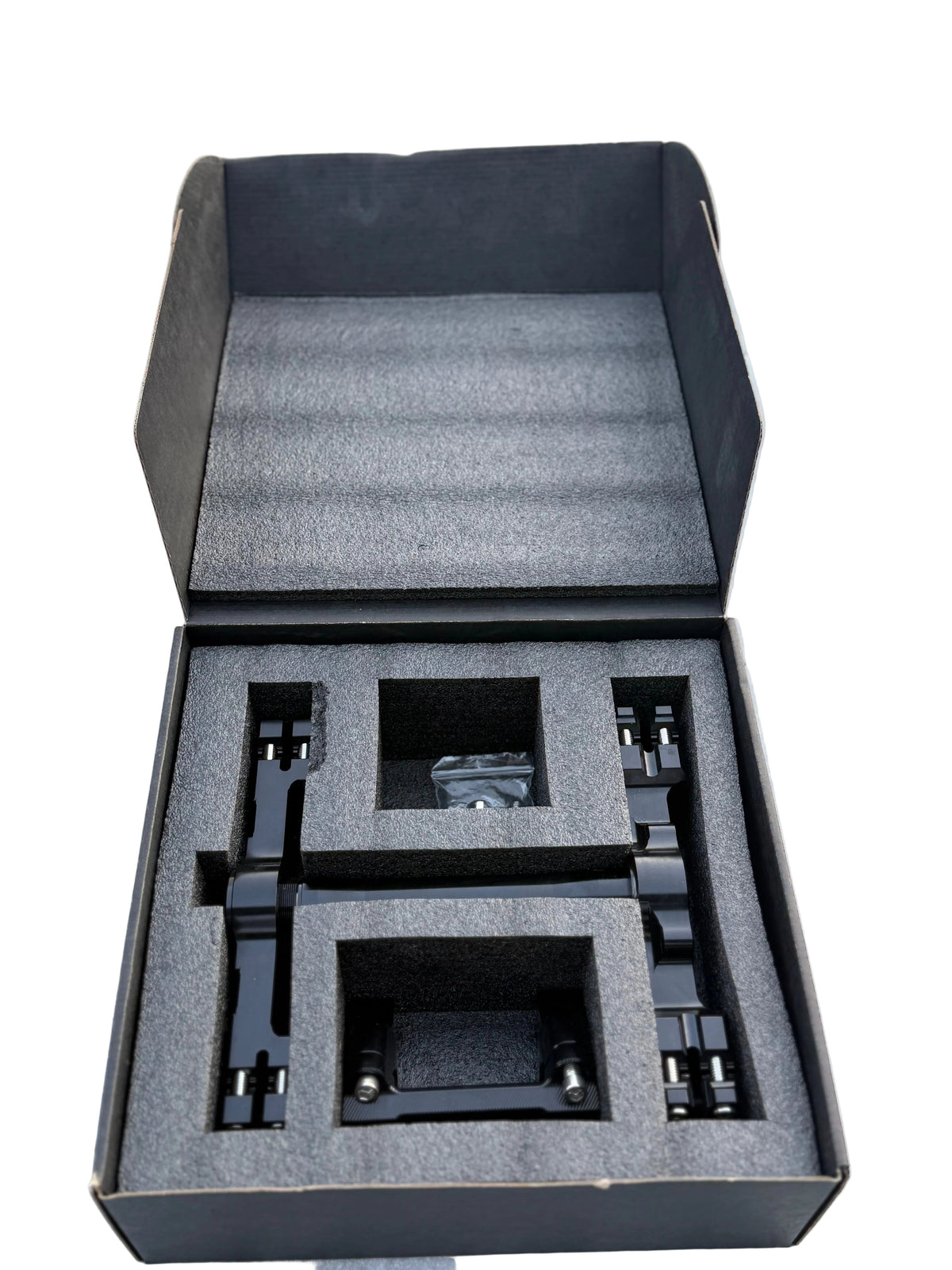 Surron Ultra Bee triple clamps and mounting components in protective packaging