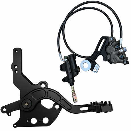 Moto footbrake pedal and mounting plate beside the hydraulic brake assembly for Surron LBX and E-Ride
