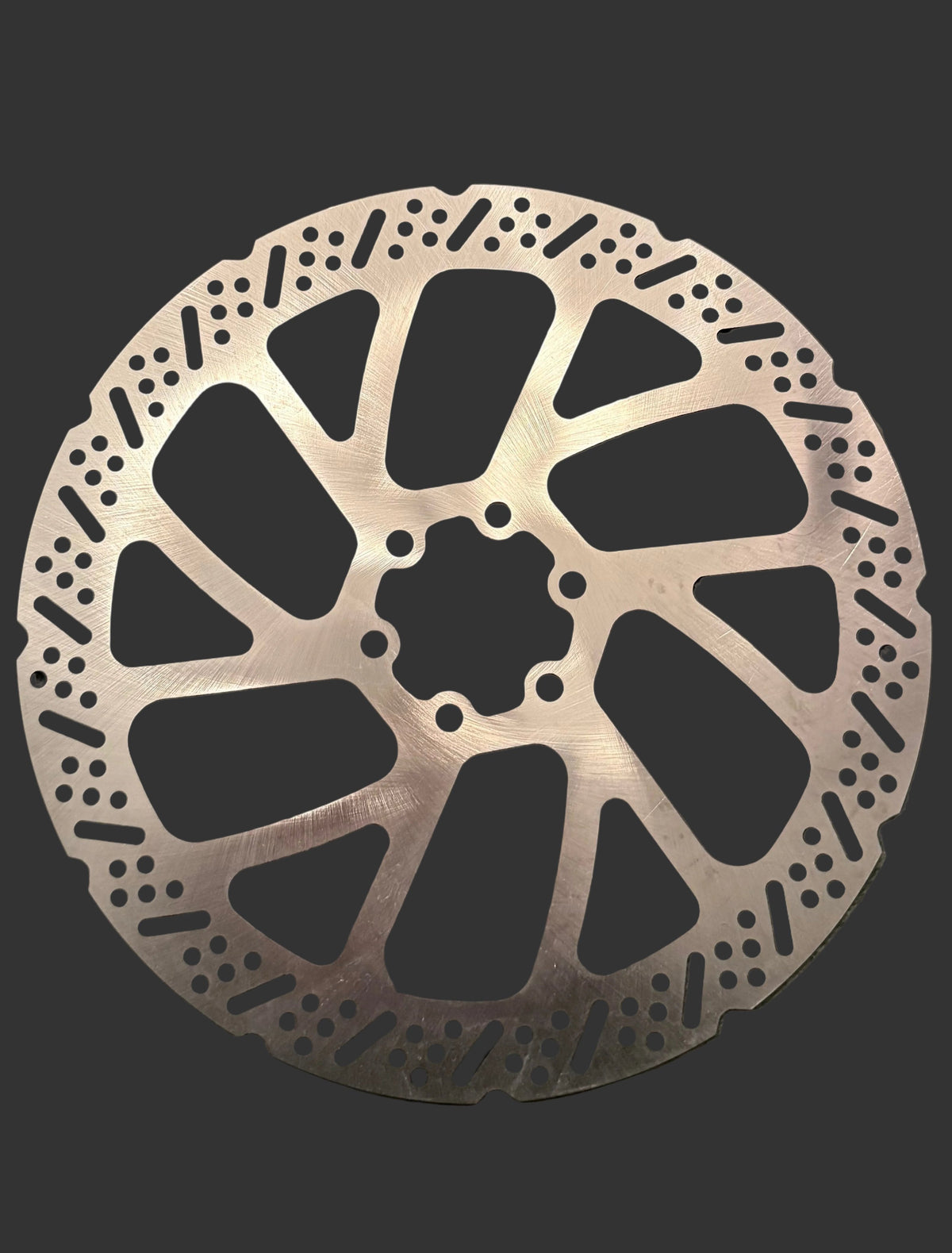 Brake rotor showing slotted surface and six-hole mounting pattern