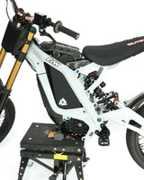 	Matte black battery wrap installed on e-bike, factory-clean blacked-out look, installed on a surron LBX