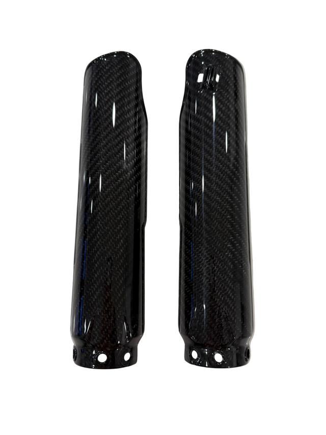 A pair of glossy black carbon fiber fork guards with a visible woven carbon pattern, shown against a plain white background.