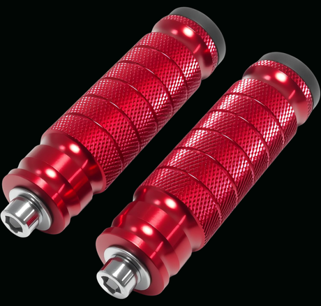 A pair of red anodized motorcycle handlebar pegs with knurled textured grips and silver metal end fittings, shown against a solid black background.