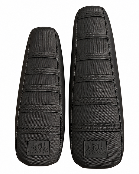 Shorter and extended Surron LBX seats shown side by side with aftermarket covers